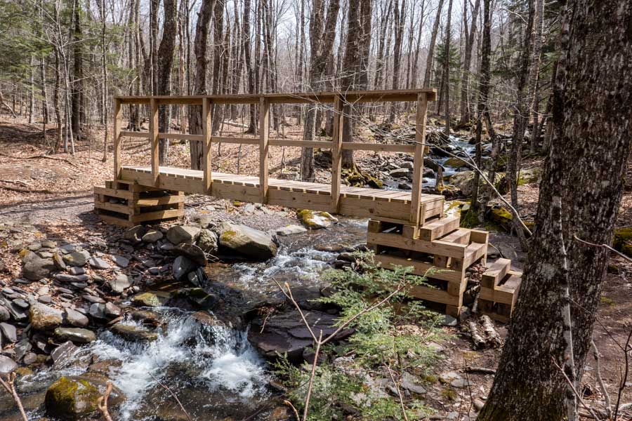 The third bridge over the batavia kill creek at the trail junction of Black Dome Ridge Trail and Batavia Kill Trail