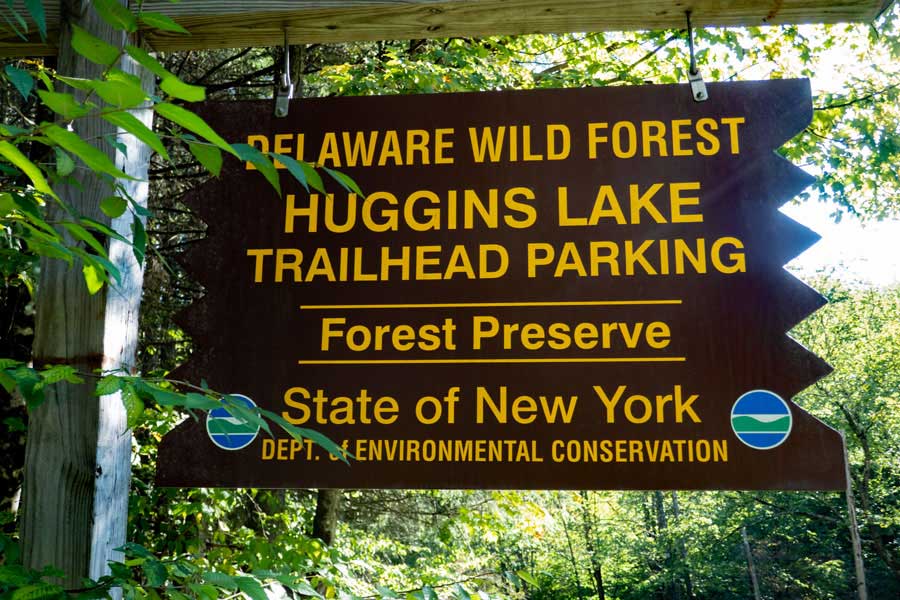 DEC sign marking the access road to the Huggins Lake Trail Parking Area