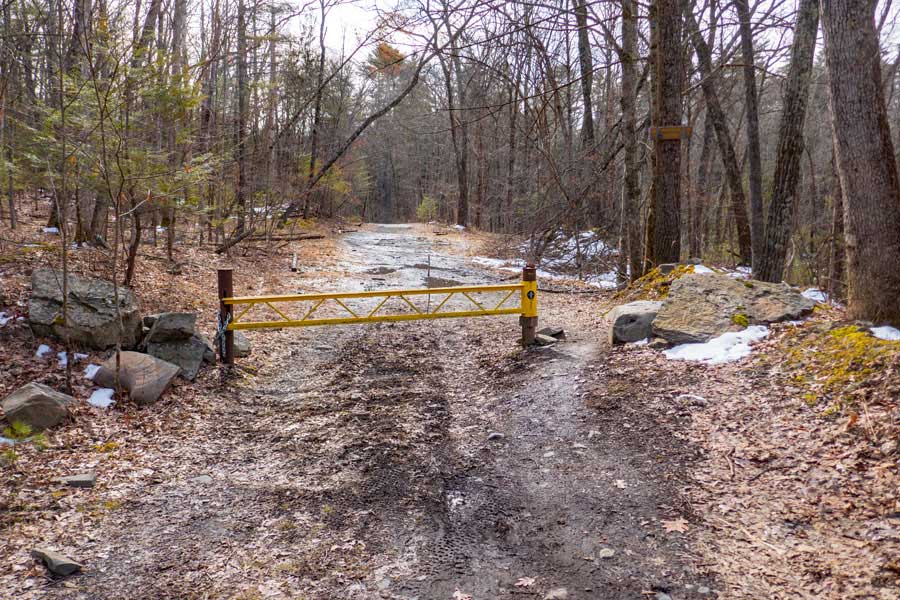 DEC gate marking where hikers and mountain bikers can travel on the Woods Road on DEC land in the  Bluestone Wild Forest